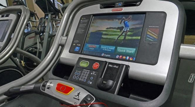 a computer screen on the dashboard of a treadmill