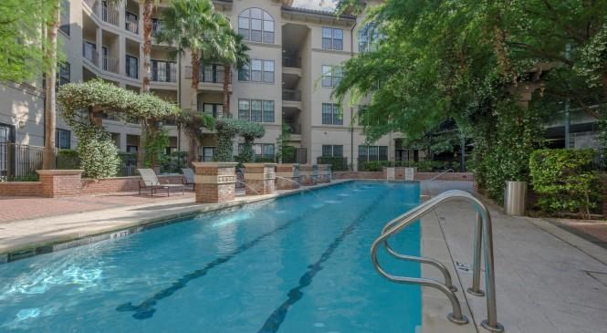 a swimming pool in front of an apartment building