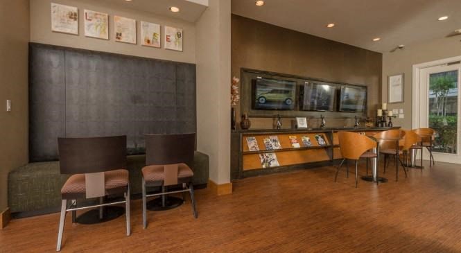 a living room with a table and chairs and a bar