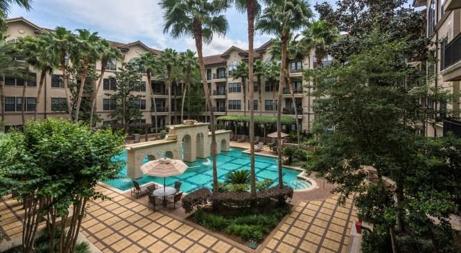 an aerial view of a large swimming pool in an apartment building