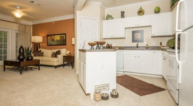 a white kitchen with a refrigerator and a sink