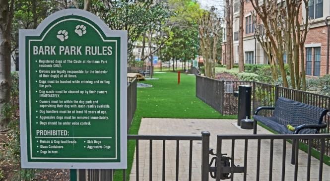 a sign for bark park rules in a park