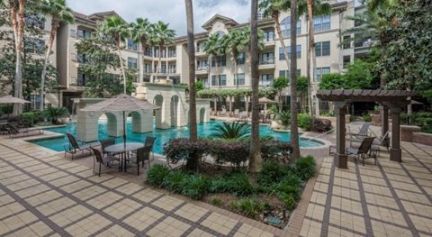 a large swimming pool in front of an apartment building