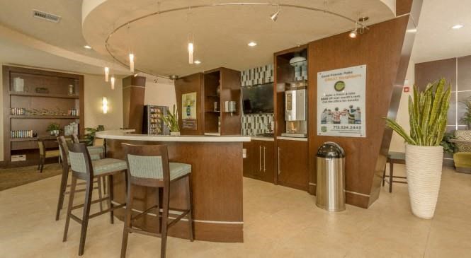 a kitchen with a bar and a dining area