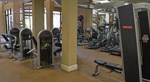 a gym with a lot of exercise equipment in it