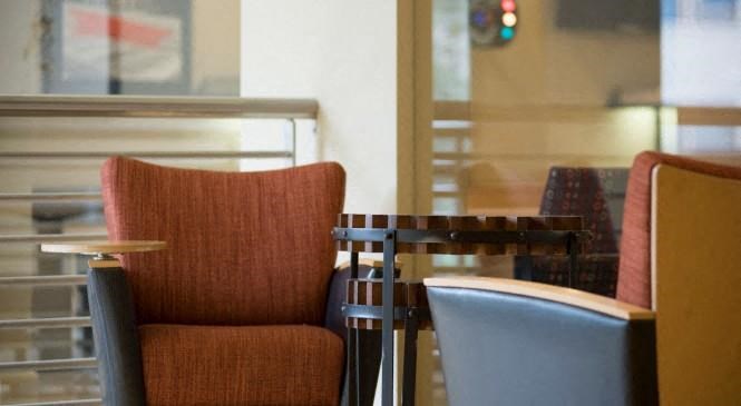 a table and chairs in a room with a window
