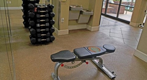 a exercise bench in a gym with a stack of weights
