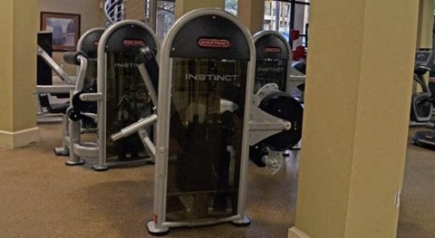 a group of exercise machines in a gym