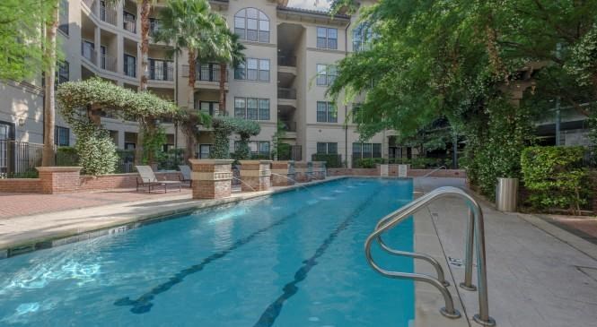 a swimming pool in front of an apartment building