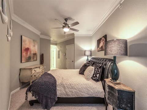 a bedroom with a bed and a ceiling fan