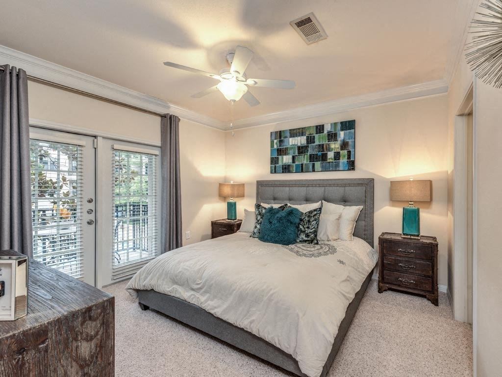 a bedroom with a bed and a ceiling fan