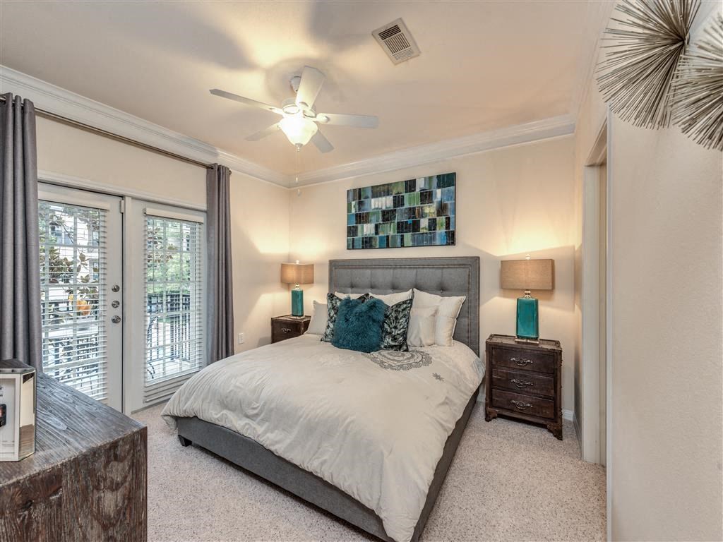 a bedroom with a bed and a ceiling fan