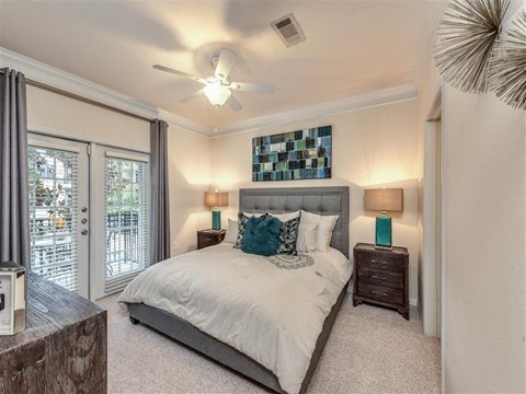 a bedroom with a bed and a ceiling fan