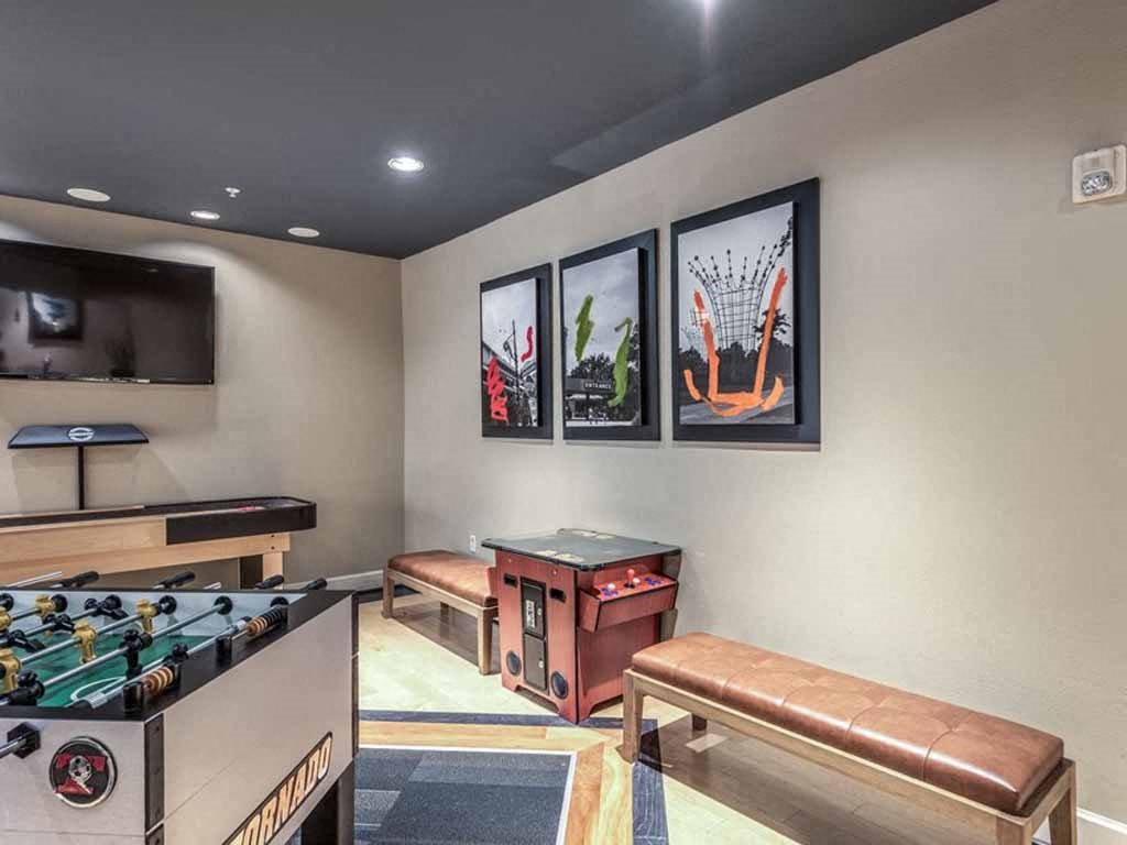 a game room with a foosball table and a regulation sized table tennis