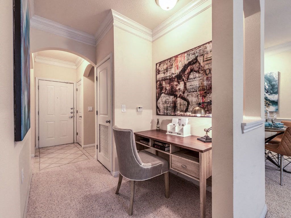 a home office with a desk and a chair in a room