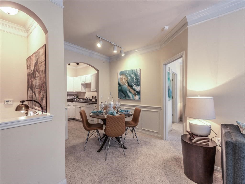 a dining room and living room with a table and chairs