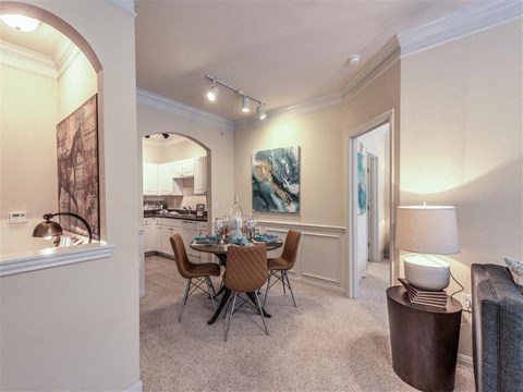 a dining room and living room with a table and chairs