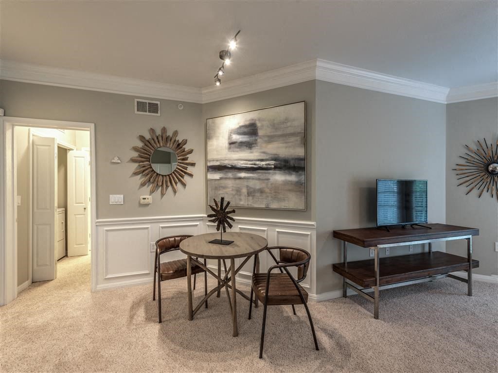 a dining room with a table and chairs