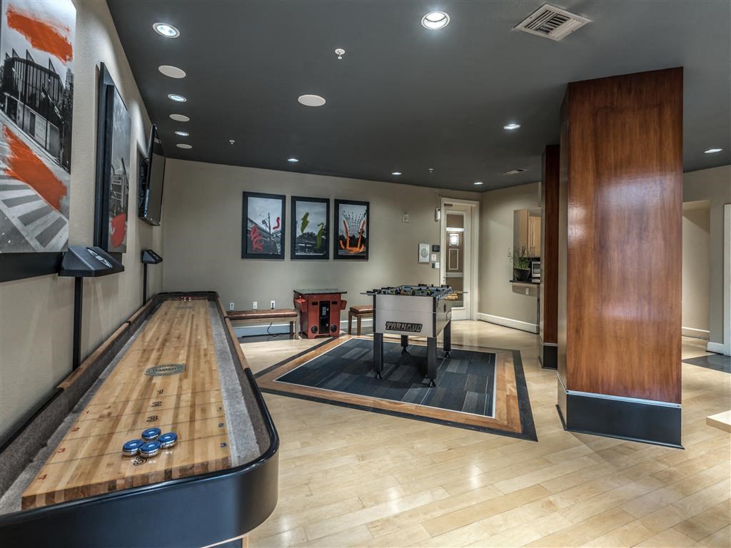 a game room with a ping pong table and a shuffleboard