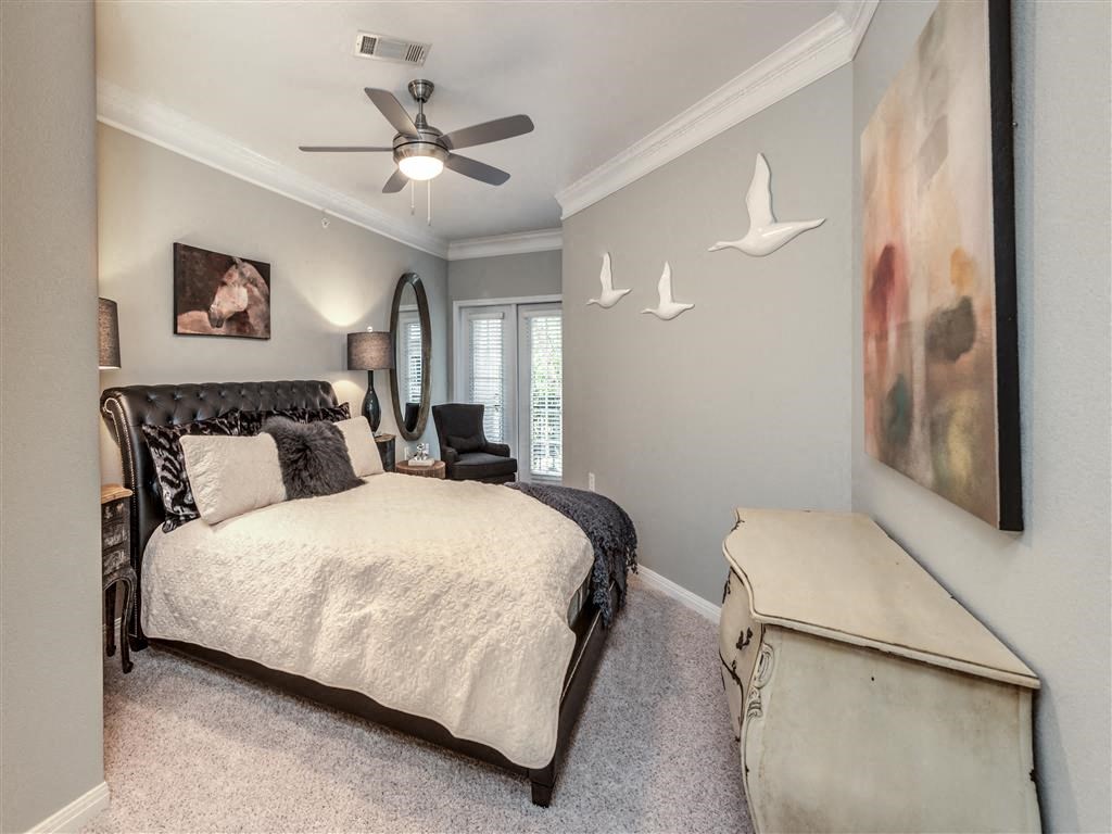 a bedroom with a bed and a ceiling fan