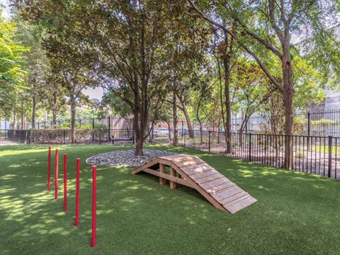 a picnic table in a park next to a fence