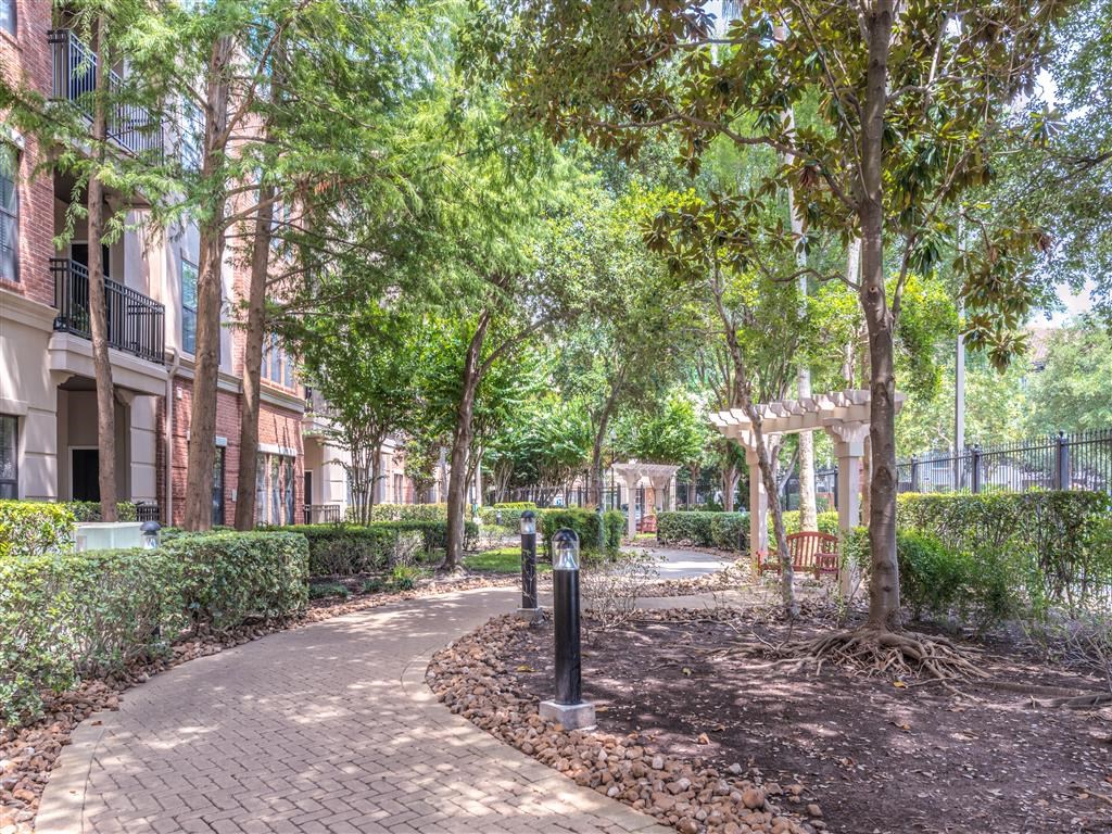 a walkway with trees in the middle of a building