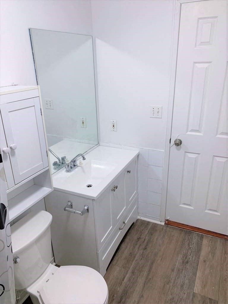 a bathroom with a sink toilet and a mirror