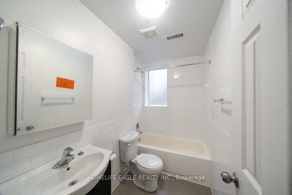 a bathroom with a sink toilet and a bath tub