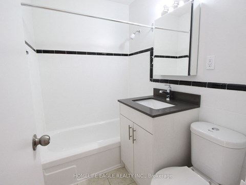 a bathroom with a sink and a toilet and a bath tub
