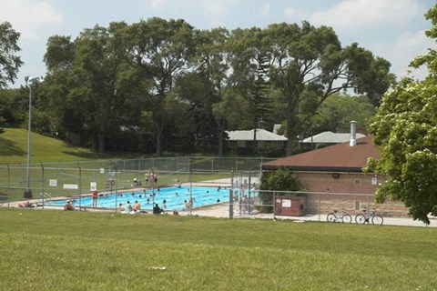 a large swimming pool in the middle of a grassy field