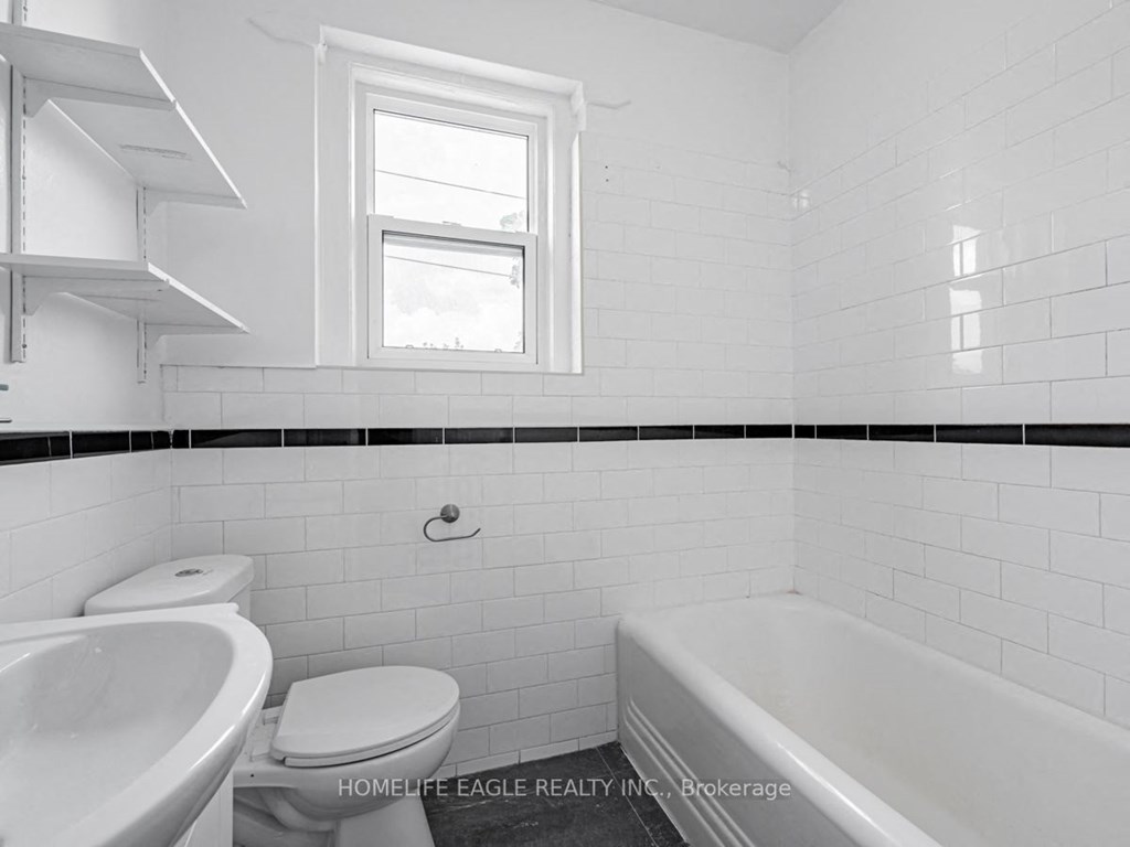 a white bathroom with a toilet sink and tub