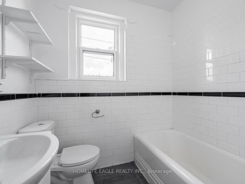 a white bathroom with a toilet sink and tub