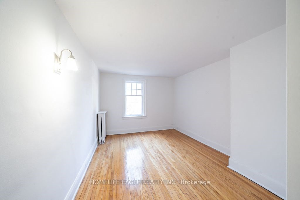 an empty room with white walls and a window