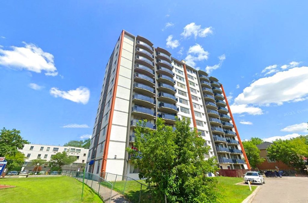 an apartment building on the side of a street
