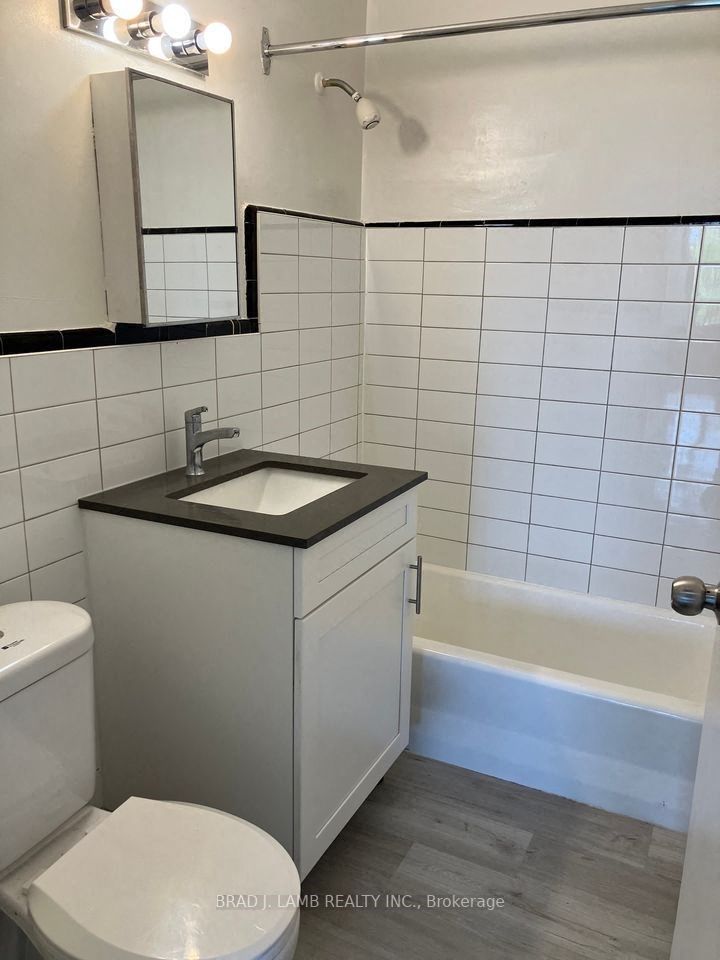 a bathroom with a sink and a toilet and a bath tub