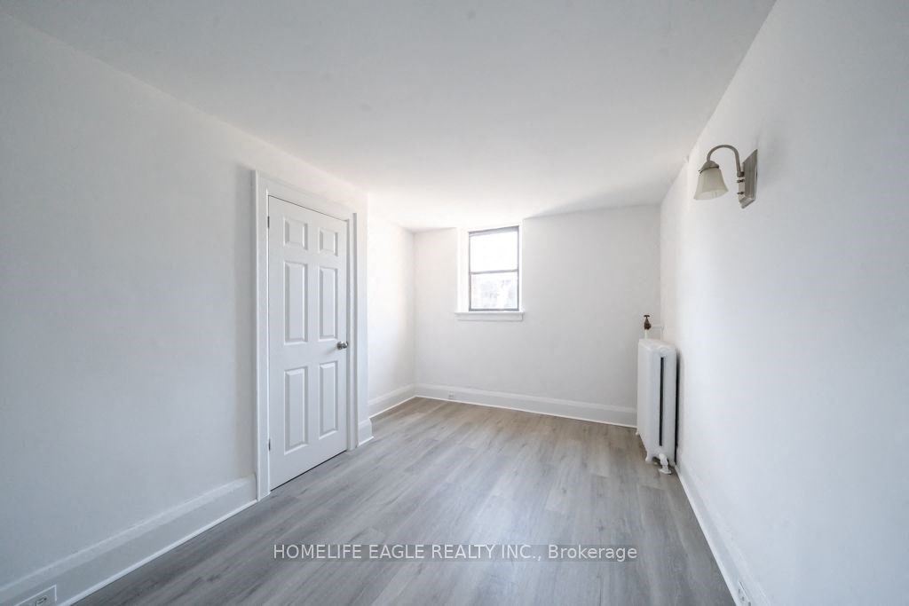 an empty room with white walls and a white door