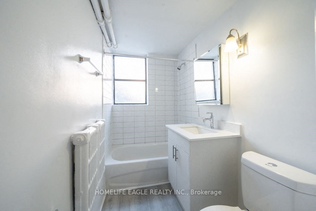 a white bathroom with a sink toilet and a tub