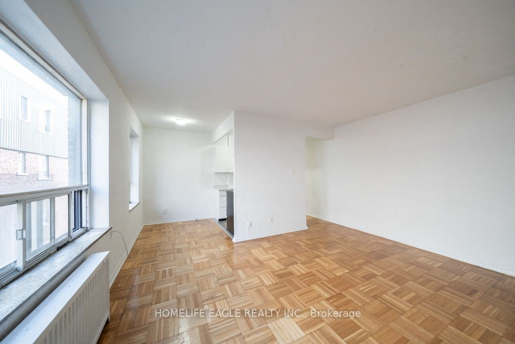 a living room with a wood floor and a window
