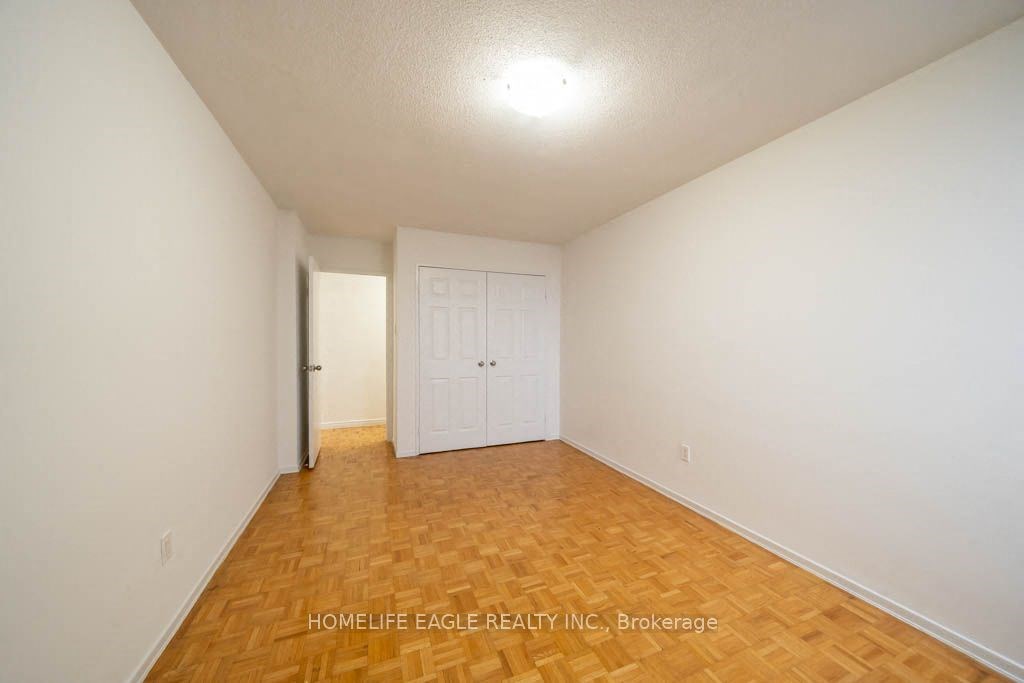 a room with a wood floor and a white door