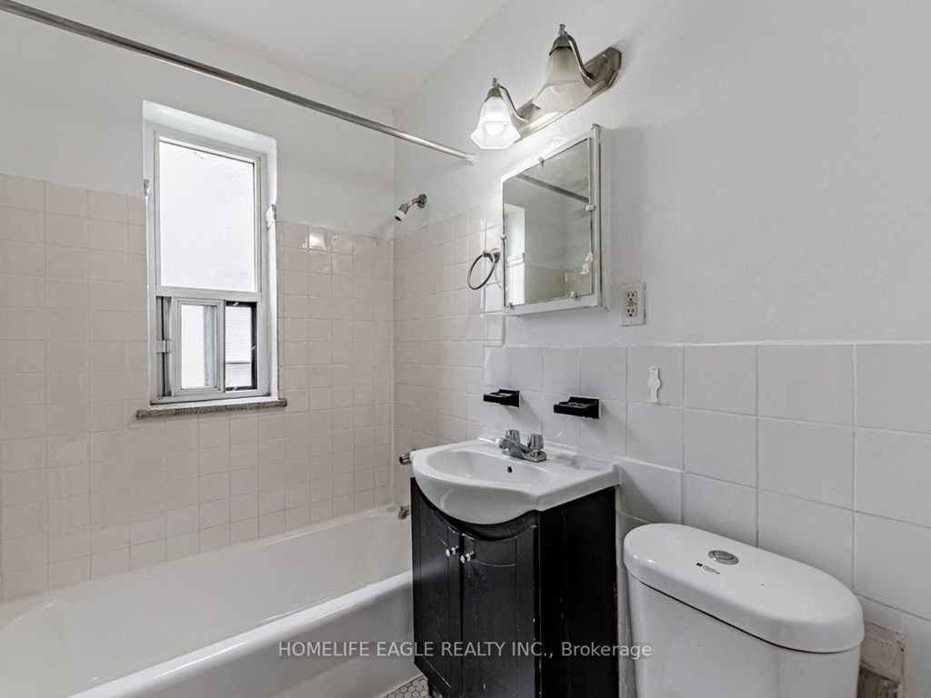 a white bathroom with a sink and a toilet