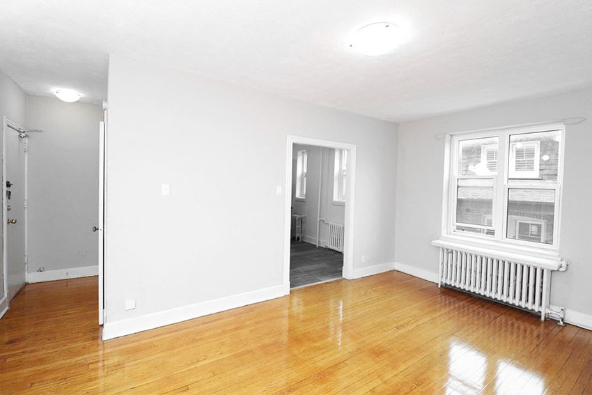 a living room with a hard wood floor and a window