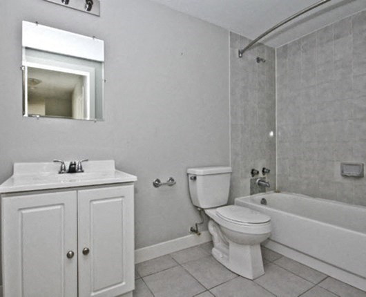 a bathroom with a toilet sink and a bath tub
