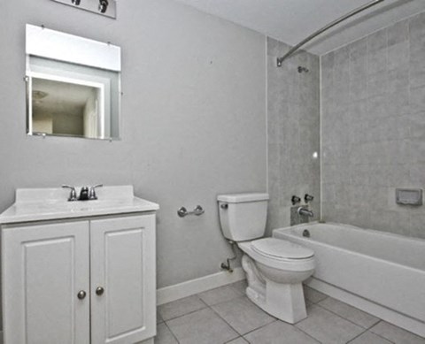 a bathroom with a toilet sink and a bath tub