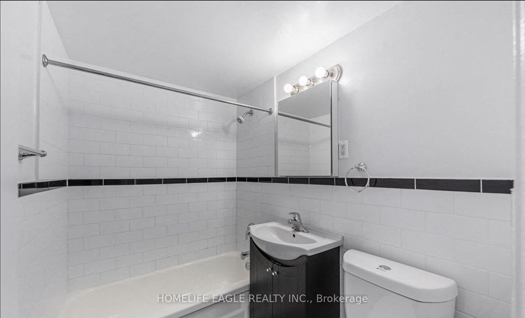 a bathroom with a sink and a toilet and a mirror