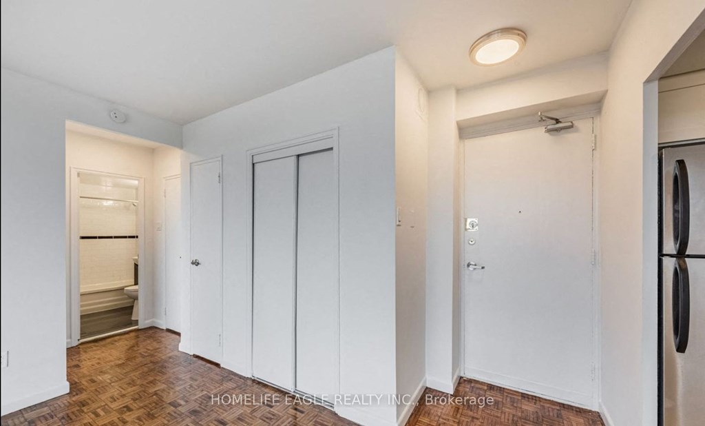 a renovated kitchen with white closets and a door to the laundry room
