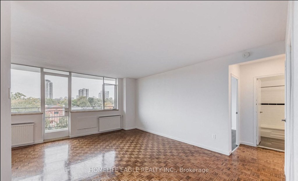 an empty living room with a view of the city