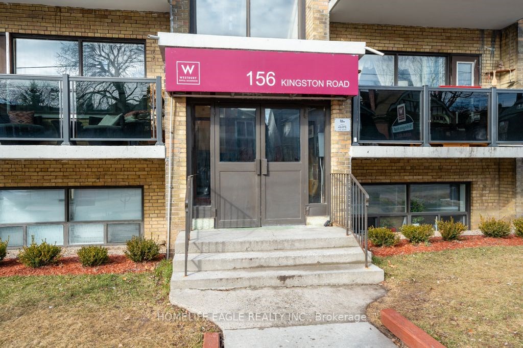 the front door of a building with a red sign on it