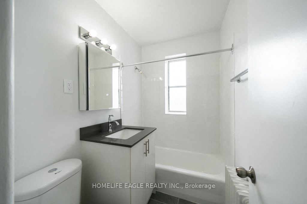 a bathroom with a sink and a toilet and a shower