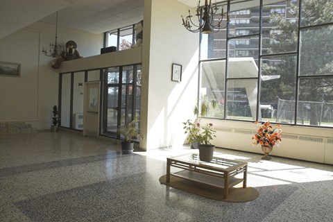 a large lobby with a coffee table and large windows