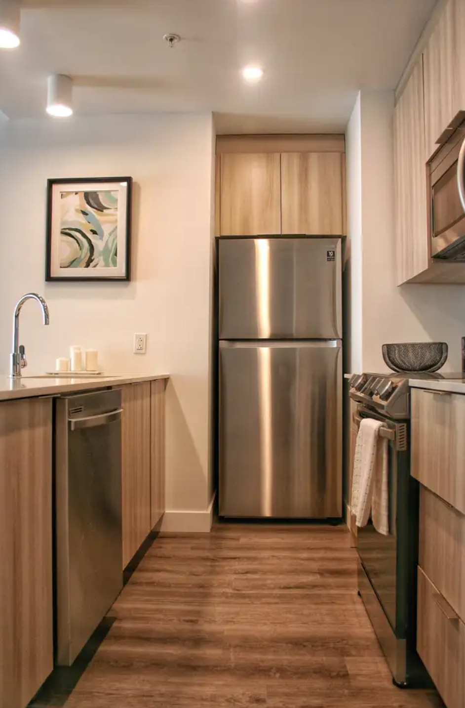a kitchen with stainless steel appliances and wooden cabinets
